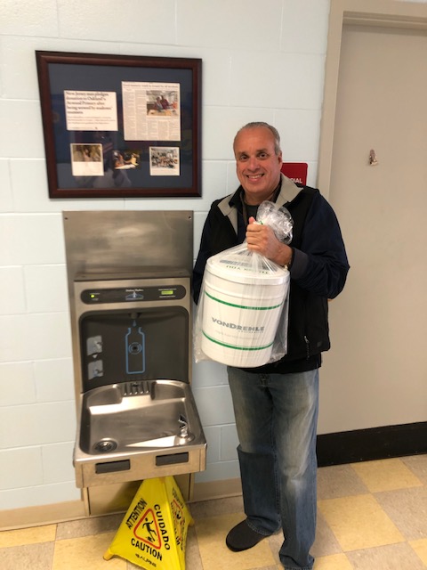 Mr. Hartzell standing next to the water fountain we purchased with his generous donation.