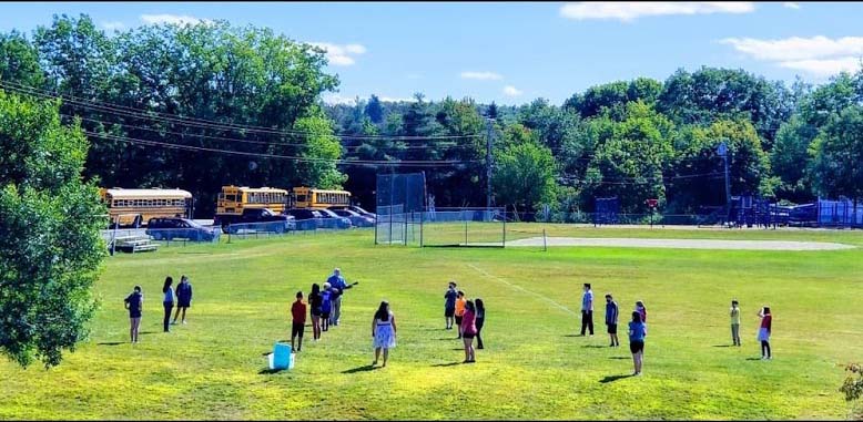 Students standing in outfield with 14 foot spacing