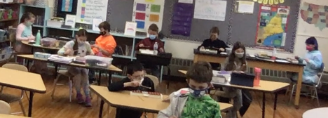Fourth-grade students are combining rhythm and pitch to play melodies on glockenspiel.