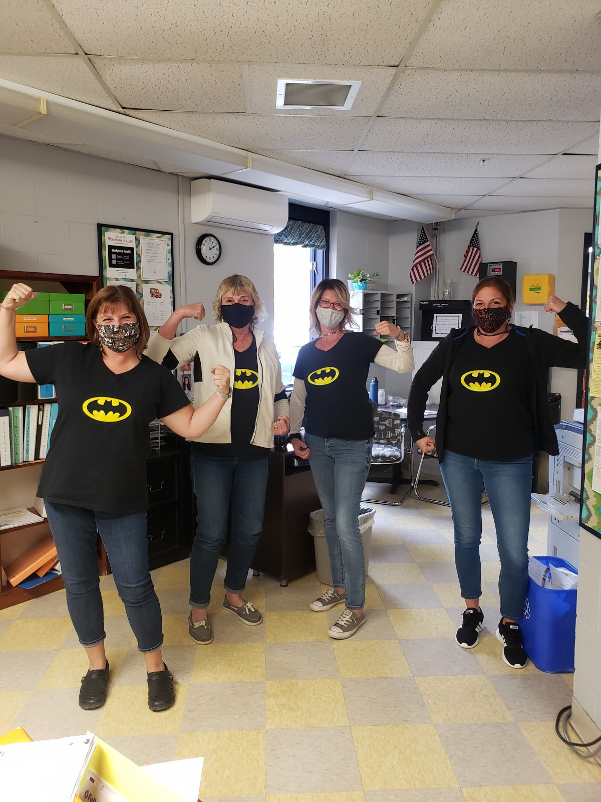 4 BCS staff members in protective masks wearing batman t-shirt on Superhero T-shirt day.